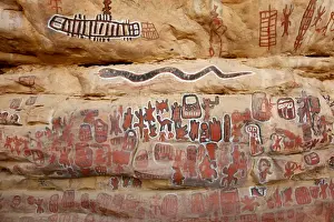 Sacred rock paintings on cliff depicting Dogon customs and stories in Songo