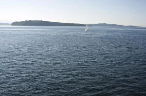 Images Dated 16th July 2008: Sailboat on the Puget Sound passes Blake Island, Washington State, United States of America