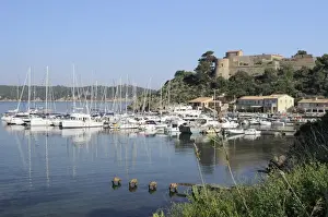 In Front Of Prints: Sailing yachts and other boats moored at Port Cros Island in front of Fort de l Eminence castle
