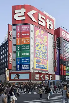 Tokyo Prints: Sakuraya camera shop at a busy intersection near the east entrance of Shinjuku station