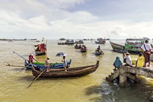 Boys Prints: Sampans and other small boats in Sittwe harbour, with people standing on the shore