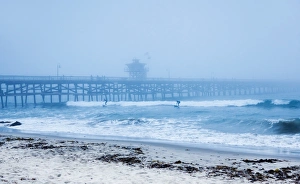 Surfers Prints: San Clemente pier with surfers on a foggy day