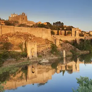Castilla La Mancha Prints: San Juan des los Reyes Monastery and town wall reflected in the Tajo River, Toledo