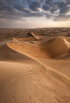 Dunes Prints: Sand dunes at sunset in the Wahiba Sands desert with clouds in the sky, Oman, Middle East