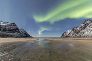 Polar Aurorae Prints: Sandy beach and snowy peaks framed by the Northern Lights (aurora borealis) in the polar night