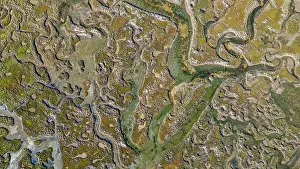Fresh Prints: Sandy wetlands with winding waterways in Olhao, Algarve, Portugal during daytime