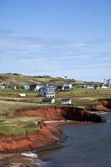 Quebec Prints: Scalloped red sandstone cliffs with houses perched on the top on the island of Havre-Aubert