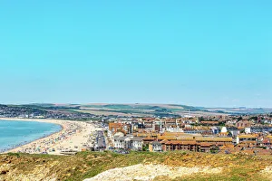Seaside Town Prints: Scenic coastal town with beach and clear blue sky
