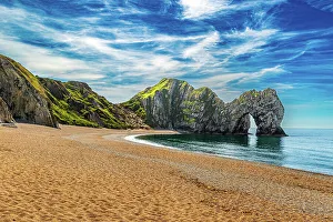 Pebble Beach Prints: Scenic view of a beach with a large rock formation