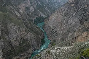 Flowing Prints: Scenic view of a river winding through a mountainous landscape in Dagestan