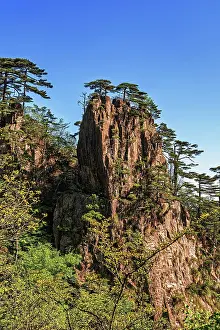 Hiker Prints: Scenic view of the rocky formations and trees along the trails of Huangshan in Anhui Province