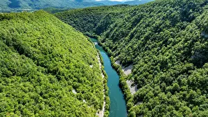 National Prints: Scenic view of Una river winding through green hills in Bosnia and Herzegovina