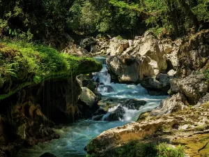 Indigenous Prints: Scenic view of the waterfall at Cahabon River in Semuc Champey Natural Monument during a sunny day in Guatemala