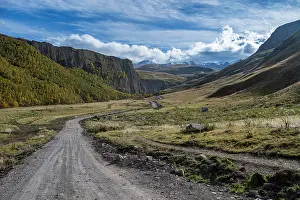 Trail Prints: Scenic view of winding dirt road through mountains in Kabardino-Balkaria