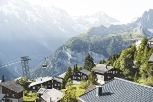 Jungfrau Prints: Schilthorn cableway passing over the alpine village of Murren, Jungfrau Region