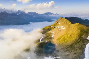 Schwarzsee Prints: Schwarziseeli lake and Stotzigen Firsten mountain emerging from a sea of clouds