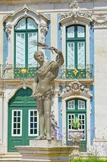 Windows Prints: Sculpture of a male figure holding a branch in front of Queluz National Palace in Lisbon