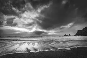 Sea stacks, tall cliffs and black basalt sandy beach at Vic on the southern coast