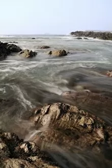 Sea swirling around rocks as tide rises, near Polzeath, Cornwall, England, United Kingdom, Europe
