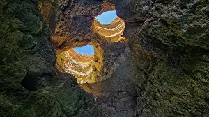 Relaxing Prints: Seacave with rock formations and openings showcasing bright sky in Carvoeiro