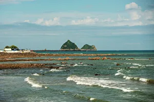 Seascape and shore line in the bay of New Plymouth, with Whareumu (Lion Rock), Moturoa island, North Island, New Zealand, Pacific