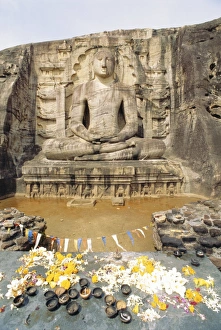 Pedestal Prints: Seated Buddha statue with offerings