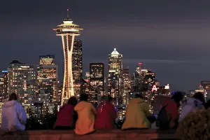 Seattle city skyline at night with illuminated office buildings and Space Needle