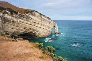 Wanderlust Prints: Sedimentary rock formations rise over clear waters at a coastal location in New Zealand near Cape Farewell