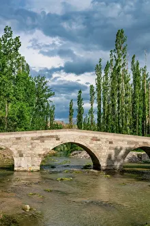 Cappadocia Prints: Selime stone bridge spans a river in Ihlara valley surrounded by nature in Cappadocia Turkey