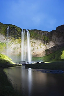Seljalandsfoss waterfall lit up at night, Southern Region, Iceland, Polar Regions