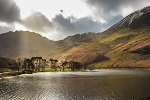 Shafts of light break through clouds to illuminate the fells in winter, Buttermere