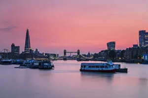 Tower Bridge Collection: The Shard, Tower Bridge and City of London skyline with river boats on the River Thames at sunset
