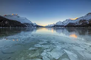Lake Sils Prints: Sheets of ice on the surface of Lake Sils in a cold winter morning at dawn, Engadine