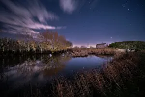 Moonlight Prints: Shepherd Hut and pond at night illuminated by moonlight