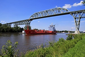 Ship on Kiel Canal going under the Railway Bridge of Hochdonn, Dithmarschen, Schleswig-Holstein