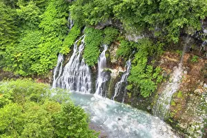 Hokkaido Prints: Shirahige waterfall flows through green trees in Biei, Hokkaido, Japan during summer