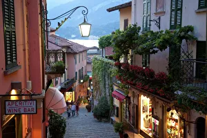 Street Light Prints: Shopping street at dusk, Bellagio, Lake Como, Lombardy, Italy, Europe