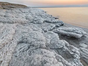 Shore with salt crystalized formation at dusk, The Dead Sea, Jordan, Middle East