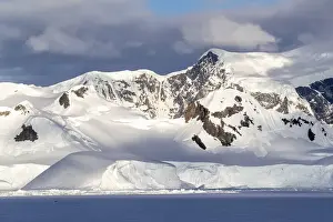 Polar Climate Prints: Shorefast ice and snow covered mountains in early season in Wilhamena Bay, Antarctica