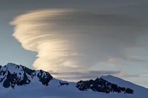 Polar Climate Prints: Shorefast ice and snow covered mountains with a lenticular cloud build up in Wilhamena
