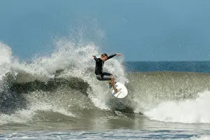 Recreational Pursuits Prints: Shortboard surfer rides a wave at this fast-growing surf beach and yoga destination