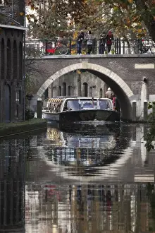 Barge Prints: A sightseeing barge under a bridge on the Oudegracht Canal in the Dutch city of Utrecht