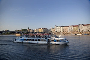 Sightseeing boat on Vltava River with East bank and Jiraskuv Bridge, Prague Sightseeing boat on Vltava River with East bank and Jiraskuv Bridge, Prague