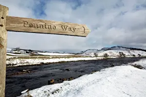 Direction Prints: Sign for the Pennine Way walking trail on snowy landscape by the River Tees