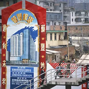 Bill Board Prints: Sign showing modern buildings in front of old huts and apartment blocks in the Shenzhen Development Zone