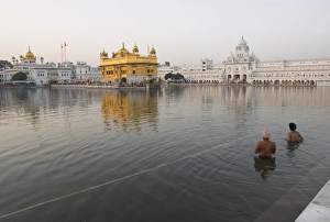 Two Sikh pilgrims bathing and praying in the early Two Sikh pilgrims bathing and praying in the early