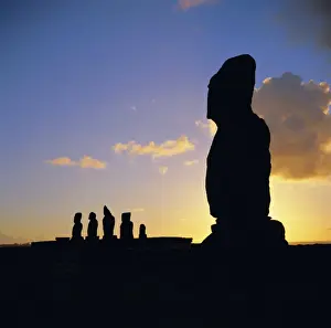 Ahu Vai Uri Prints: Silhouette of Ahu Tahai in foreground and behind the five moai (statues) of Ahu Vai Uri
