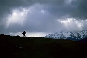 Back Pack Prints: Silhouette of backpacker making way over pass in the Torres Circuit hike