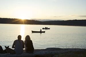 Images Dated 26th June 2010: Silhouette of couple with dog watching sunset at Lisabeula Beach, Vashon Island