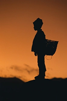 Child Prints: Silhouette of local boy at sunset